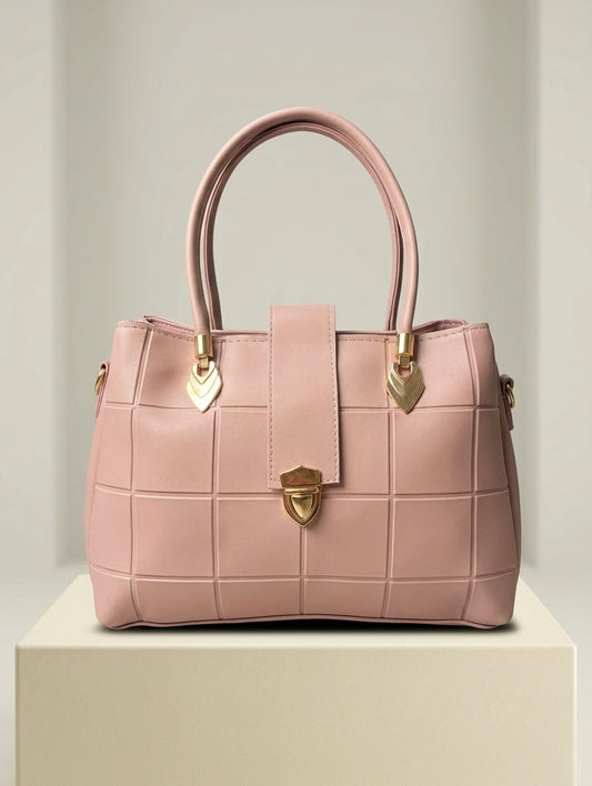 Rose pink quilted satchel with gold turn-lock closure and heart charms front view