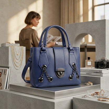 Midnight navy blue chain-lock satchel displayed in luxury boutique setting