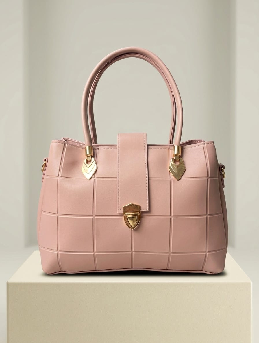Rose pink quilted satchel with gold turn-lock closure and heart charms front view